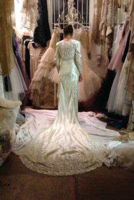 Woman trying on vintage wedding dress at Jane Bourvis