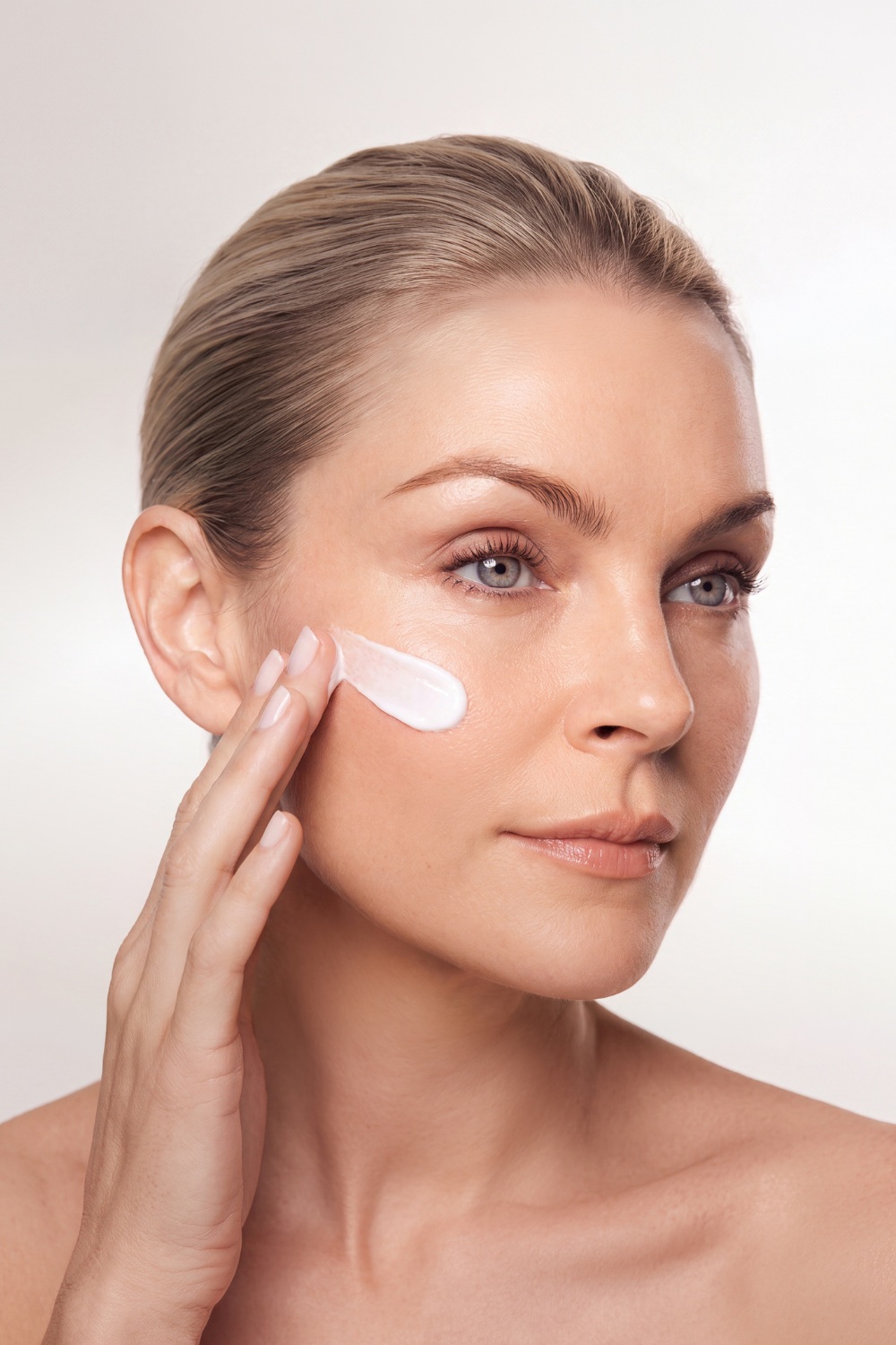 Woman applying Lyma products