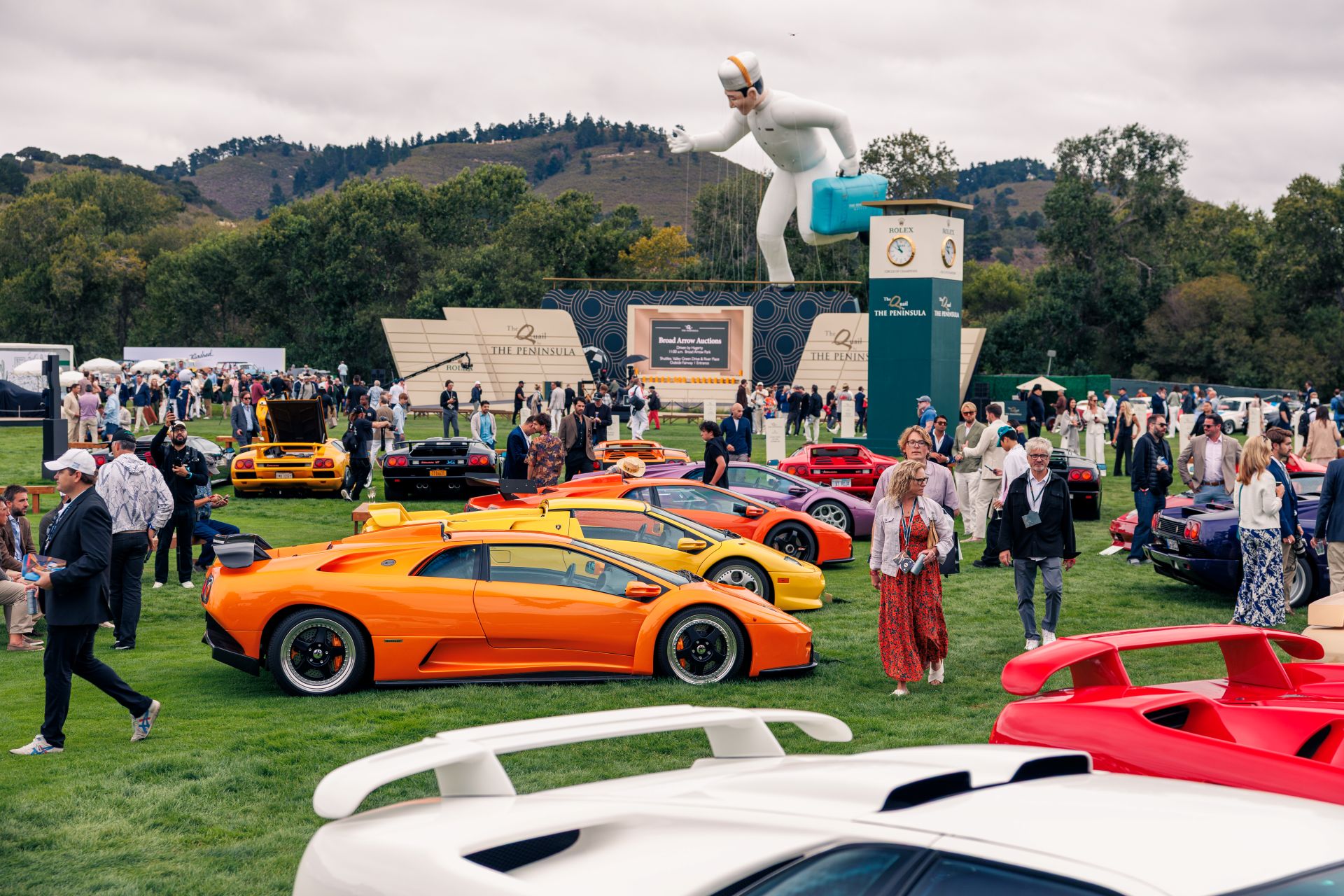 Atmosphere at the Quail with a line of supercars